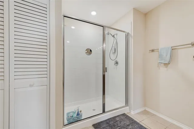 a bathroom with a shower and a glass door