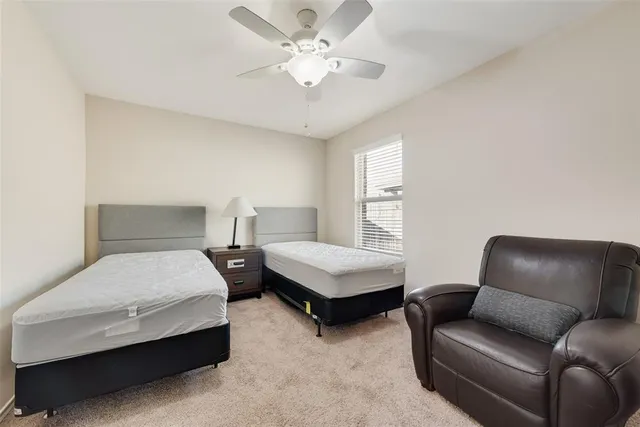 a bedroom with bed couch and window