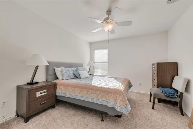 a bedroom with a bed and a chair