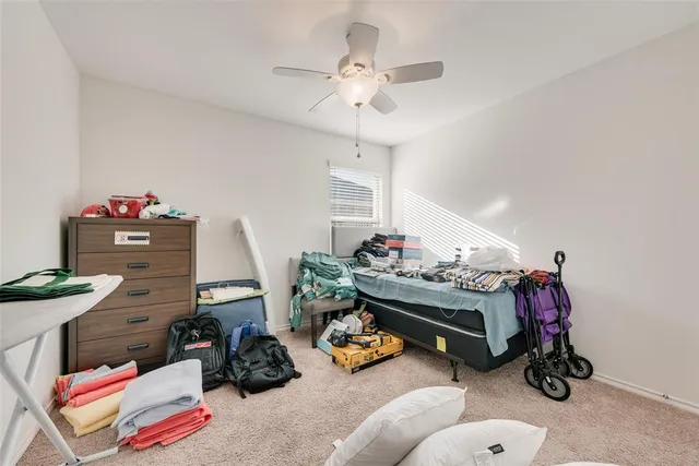 a bedroom with bed and a chandelier