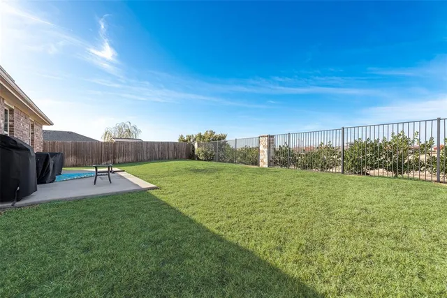 a swimming pool with lots of green space