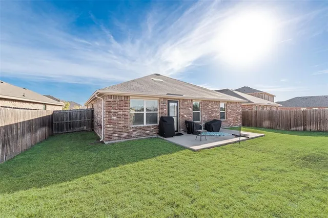 a patio that has couches chairs and a big yard