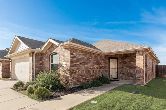 a view of a brick house with a large windows