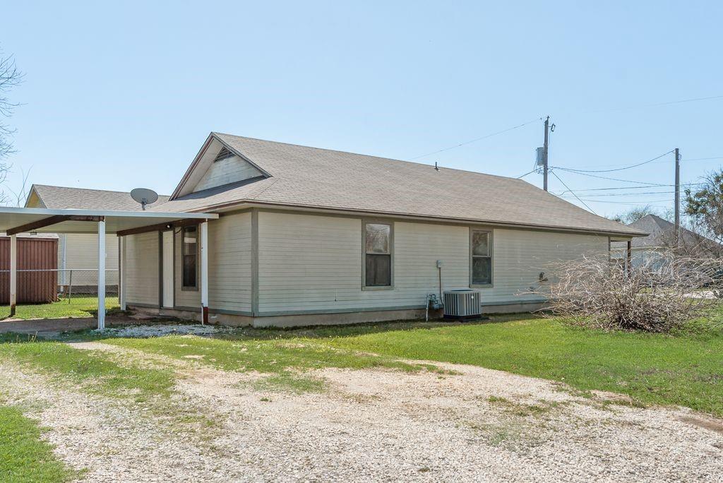 301 Lipscomb Street Cleburne, TX 76031 - Photo 19 of 21 a front view of a house with a yard and garage