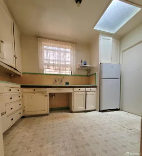 a kitchen with a refrigerator and a sink