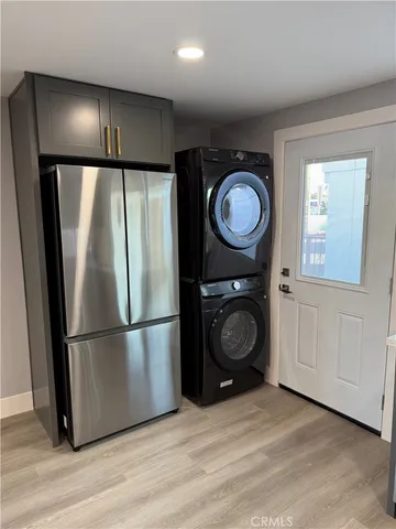 a kitchen with a refrigerator and a washer