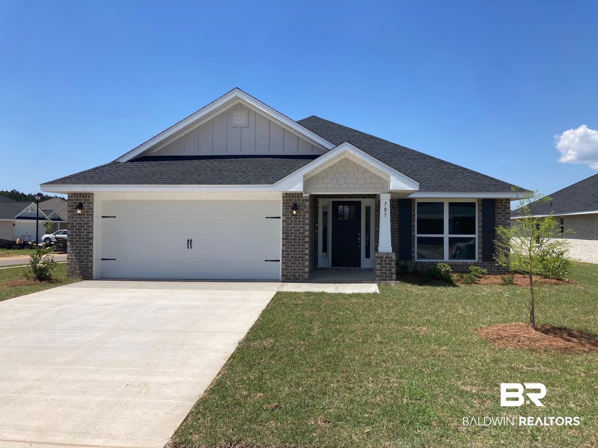705 Mayflower Drive Foley, AL 36535 - Photo 1 of 19 Craftsman inspired home with board and batten siding, a garage, a front yard, and brick siding