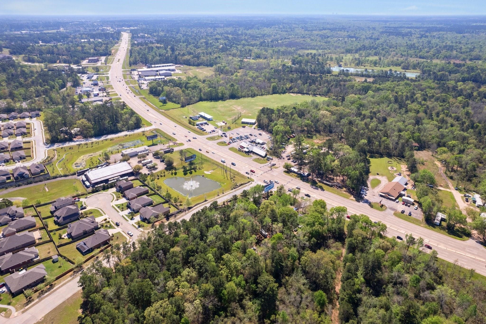 6020 Highway 105 Conroe, TX 77304 - Photo 8 of 10 an aerial view of residential houses with outdoor space