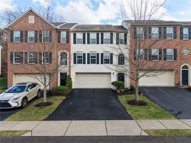 a front view of a building with a garden