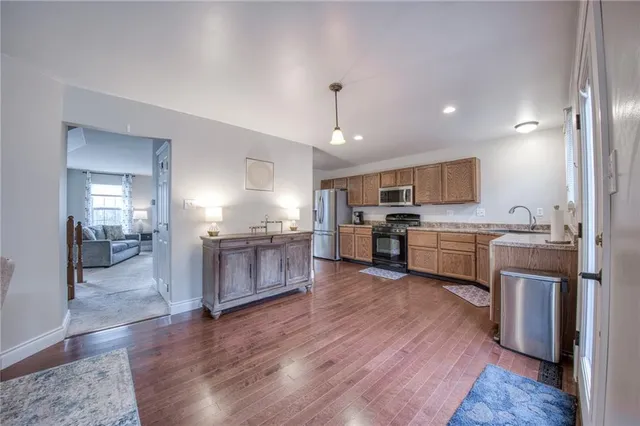 a kitchen with a refrigerator and a stove top oven