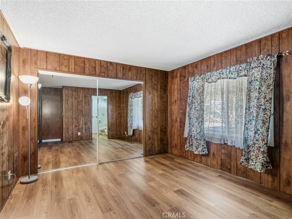 599 Smoke Tree Road Pinon Hills, CA 92372 - Photo 15 of 34 a view of a room with wooden floor and door