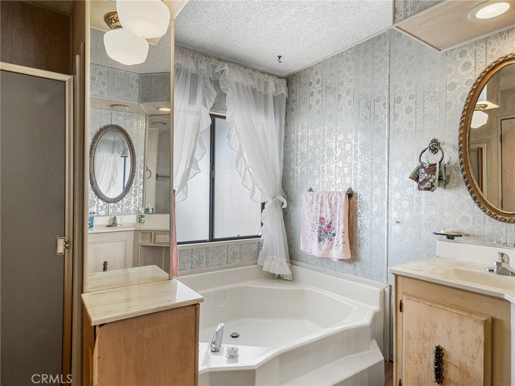 599 Smoke Tree Road Pinon Hills, CA 92372 - Photo 18 of 34 a bathroom with a sink vanity mirror and a bathtub