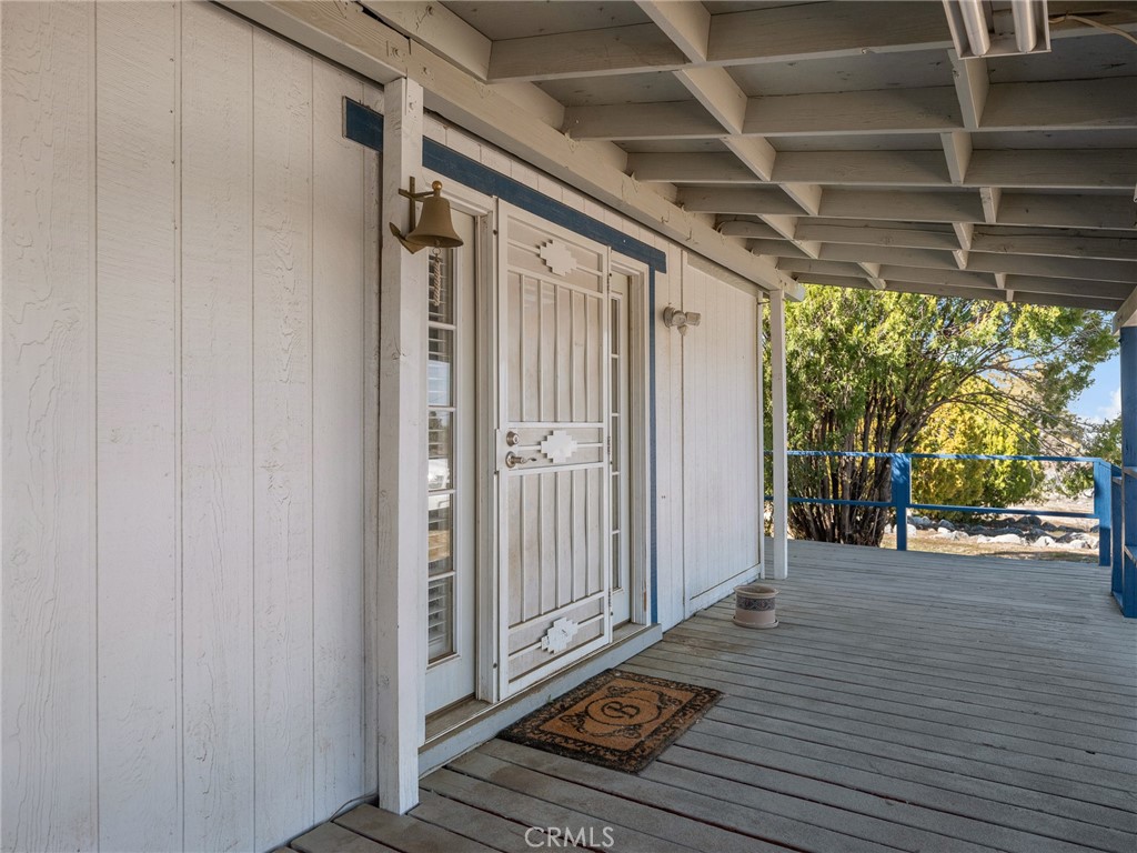 599 Smoke Tree Road Pinon Hills, CA 92372 - Photo 2 of 34 a view of a porch with wooden floor