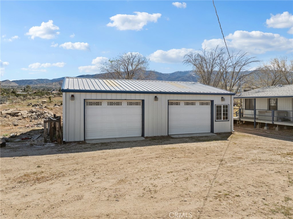 599 Smoke Tree Road Pinon Hills, CA 92372 - Photo 28 of 34 a front view of a house with a large window