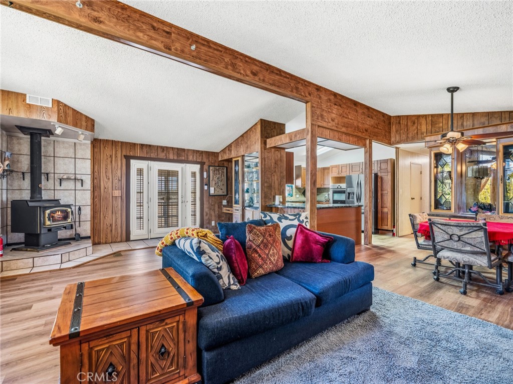 599 Smoke Tree Road Pinon Hills, CA 92372 - Photo 8 of 34 a living room with furniture and a floor to ceiling window