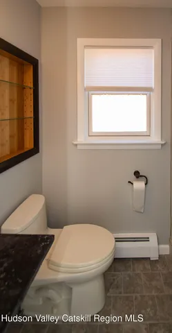 an empty room with closet and a chandelier fan