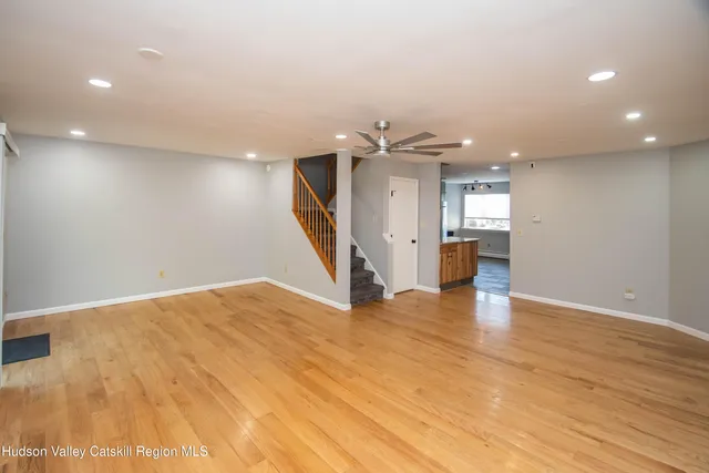 a view of empty room with wooden floor