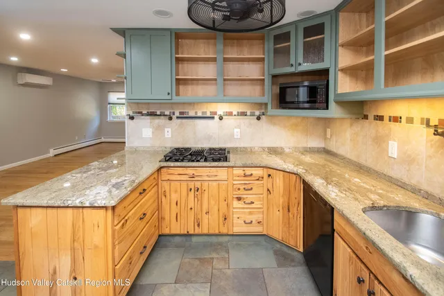 a kitchen with stainless steel appliances granite countertop a sink and a microwave