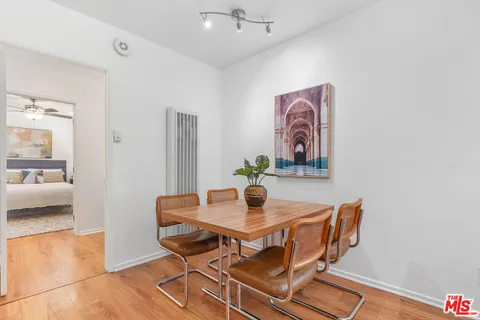 a dining room with furniture and wooden floor