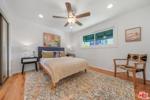 a bedroom with a bed and a desk