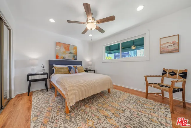 a bedroom with a bed and a desk