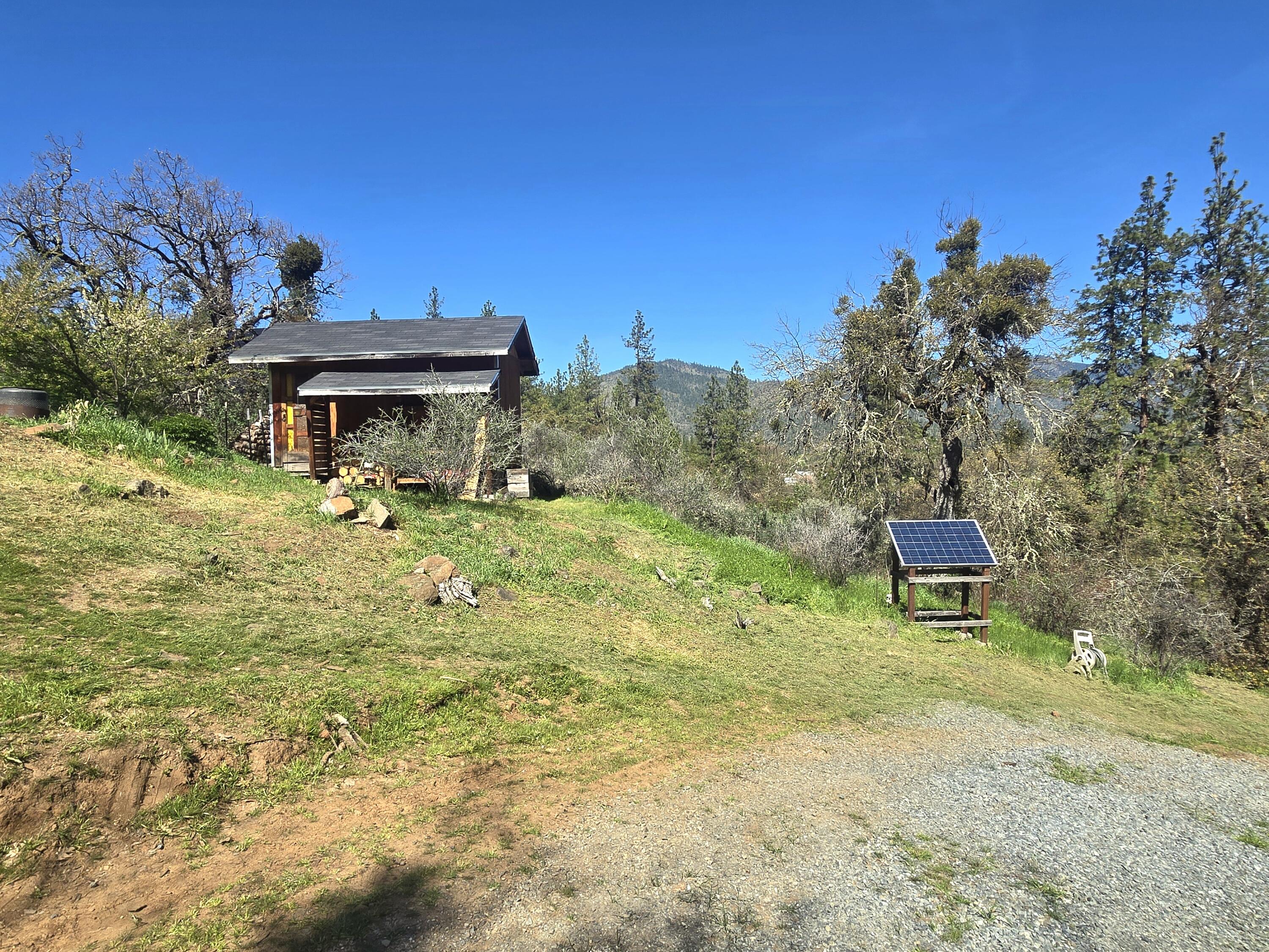 12726 Water Gap Road Williams, OR 97544 - Photo 31 of 47 a view of a house with a yard