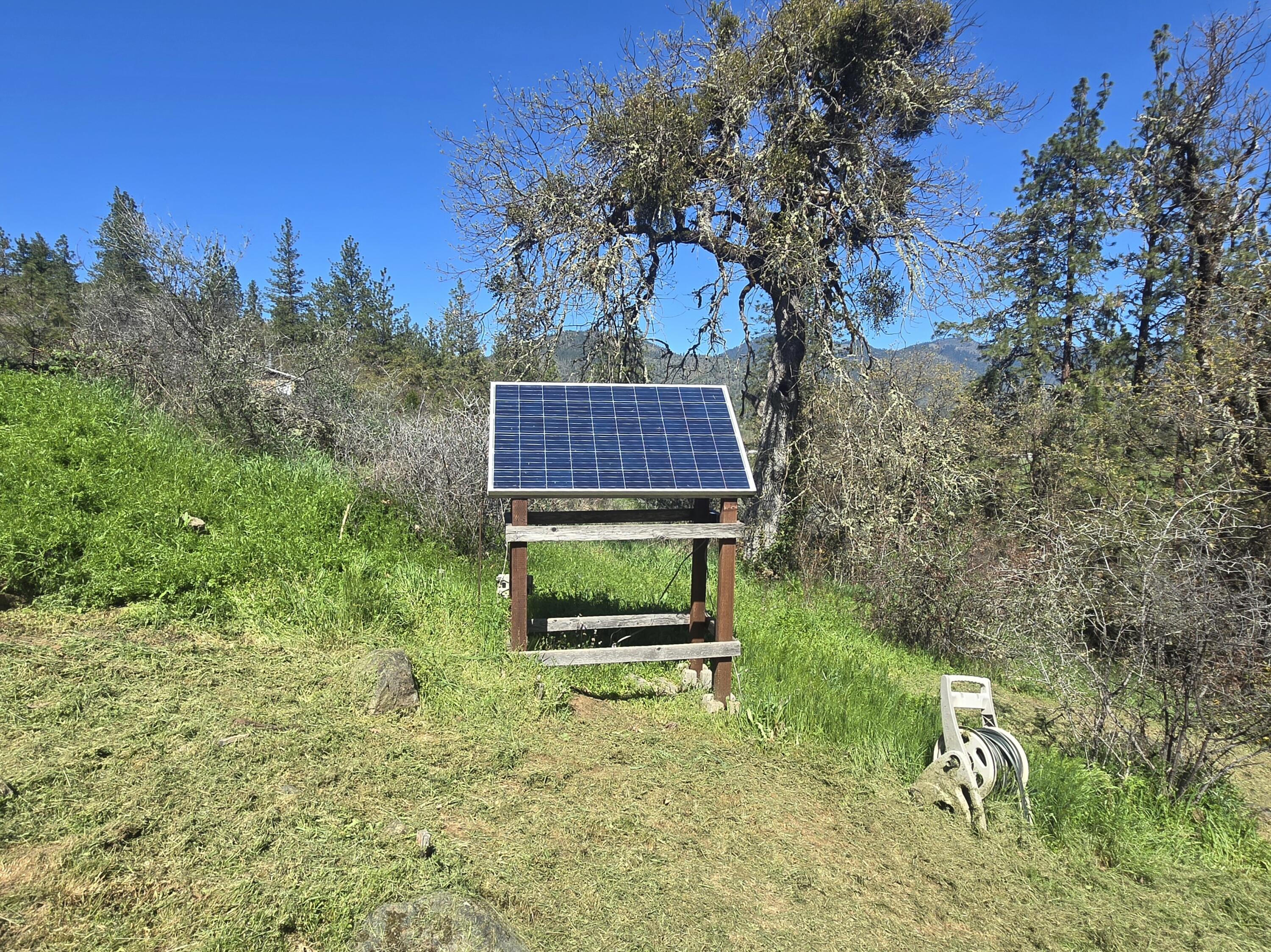12726 Water Gap Road Williams, OR 97544 - Photo 32 of 47 a backyard of a house with lots of green space