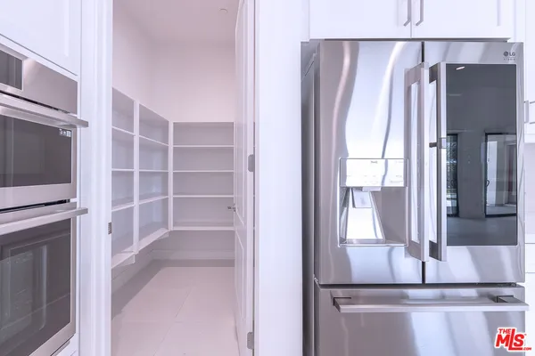 an empty room with windows and entrance