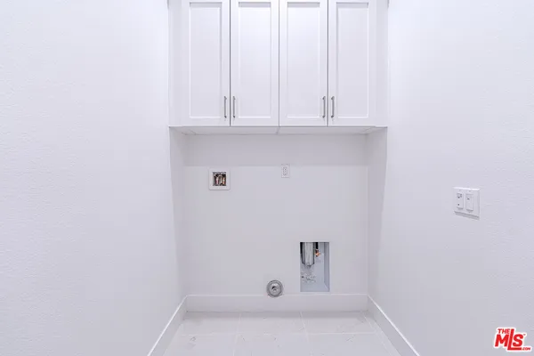 a white toilet sitting next to a white cabinet