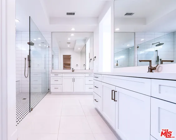 a bathroom with a sink vanity mirror and toilet