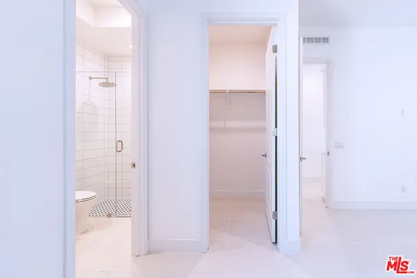 an empty room with windows and closet