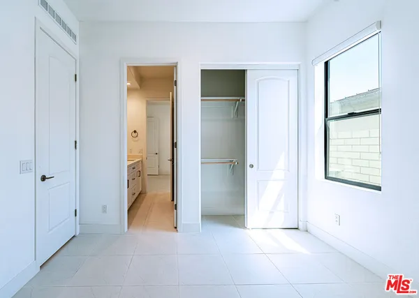 a large white room with windows and a fireplace