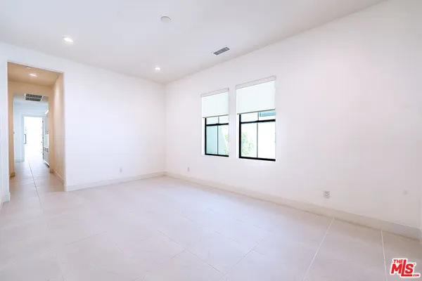 a bathroom with a toilet a sink a vanity and mirror