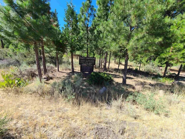 a backyard of a house with a yard and outdoor seating