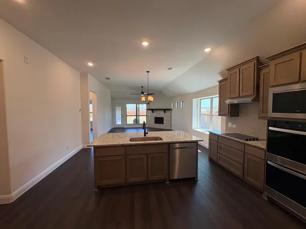 a kitchen with stainless steel appliances granite countertop a sink and cabinets