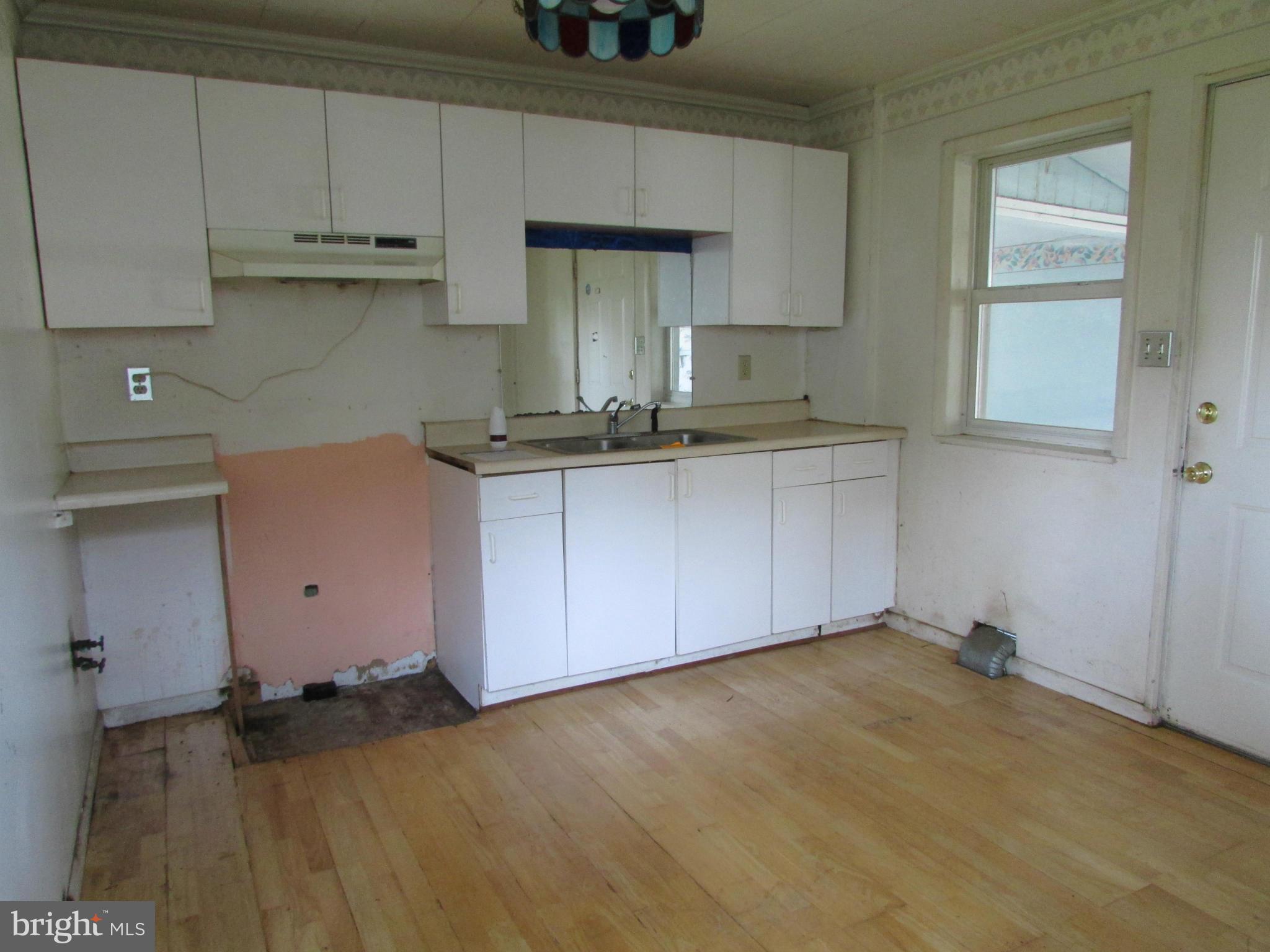 1416 2nd Road Baltimore, MD 21220 - Photo 4 of 11 a kitchen with granite countertop a sink a stove and cabinets