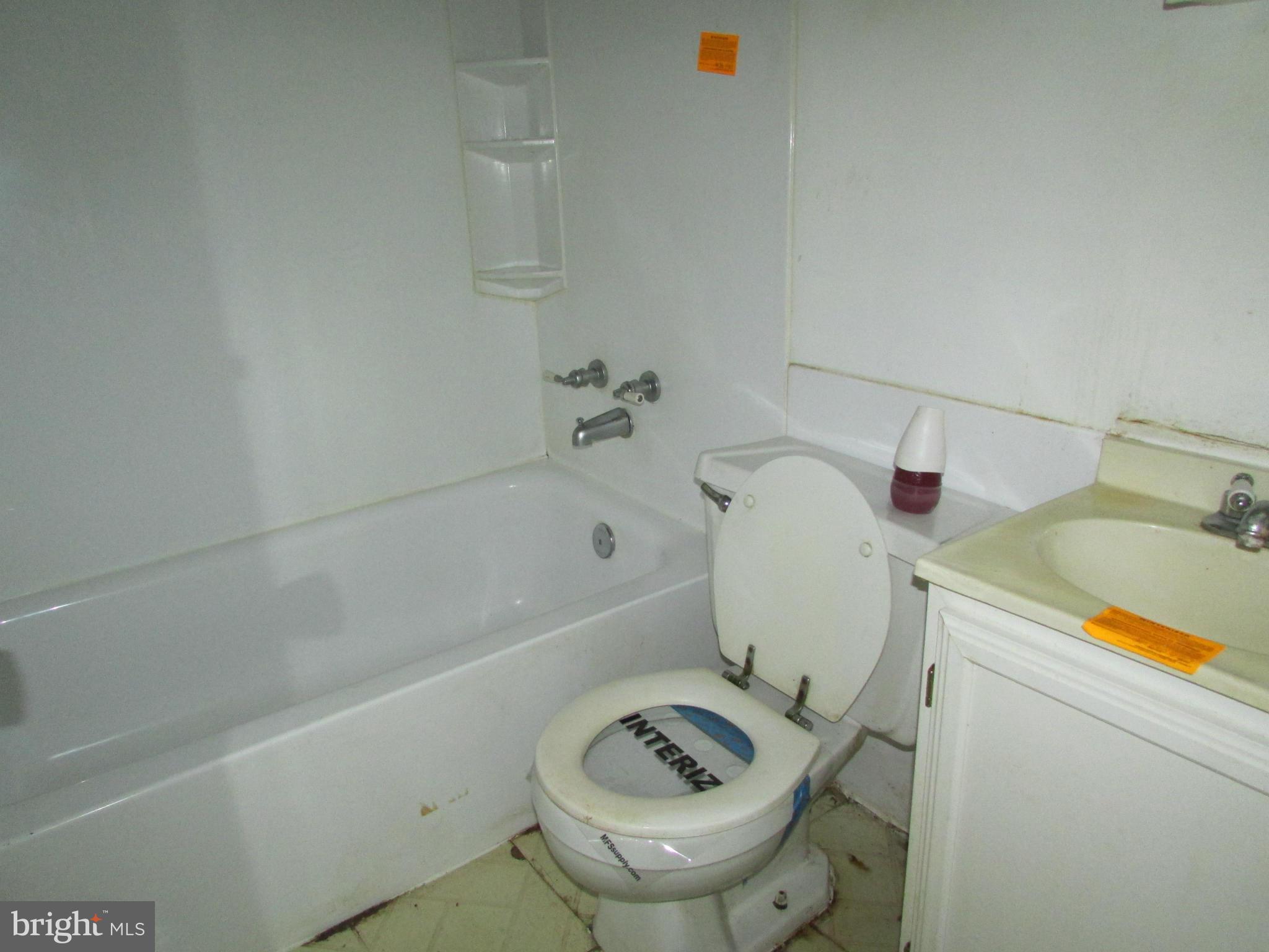 1416 2nd Road Baltimore, MD 21220 - Photo 8 of 11 a bathroom with a sink a toilet and bathtub