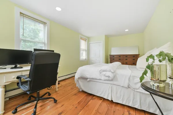a bed sitting in a bedroom next to a window