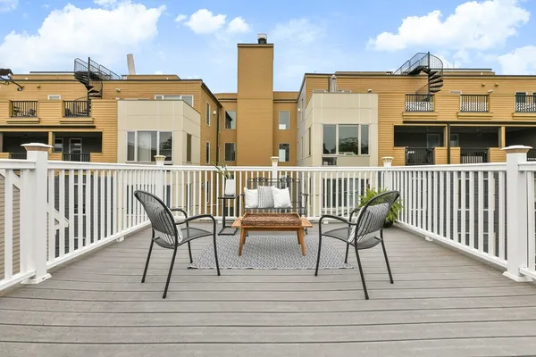 a view of a deck with table and chairs