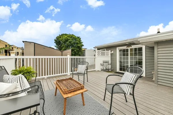 a balcony with furniture and a potted plant