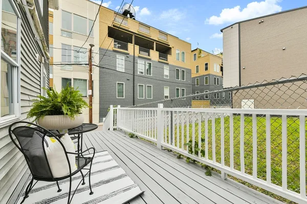 a balcony view with a seating space