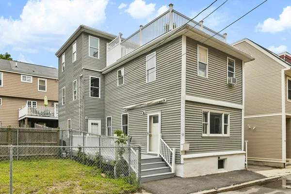 a view of a house with a yard and stairs