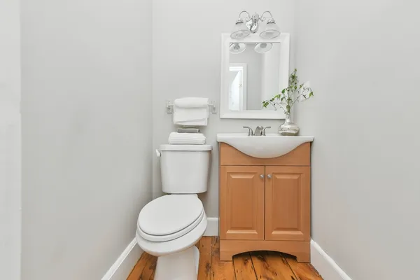 a bathroom with a sink mirror vanity and toilet