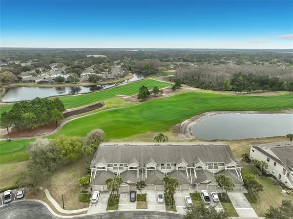 an aerial view of a house with yard swimming pool and outdoor seating