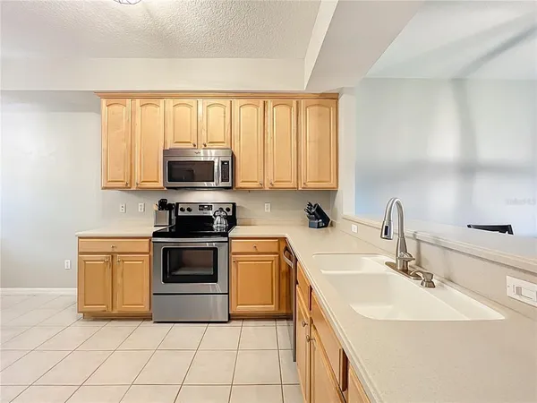 a kitchen with a refrigerator sink and cabinets