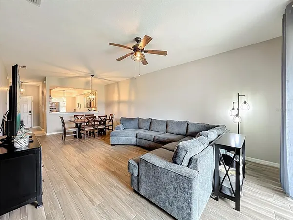 a spacious bedroom with a bed and wooden floor