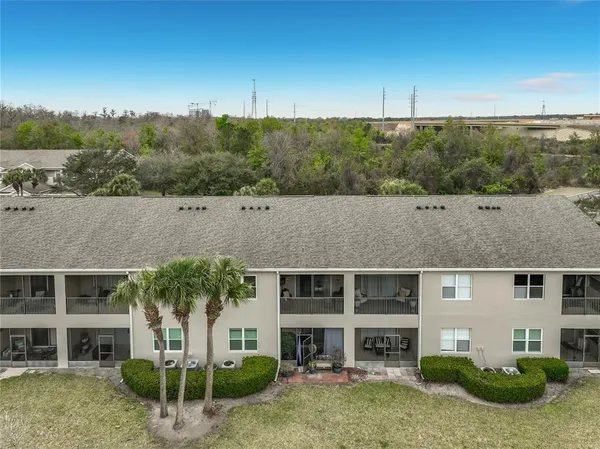 an aerial view of a house with a yard and lake view