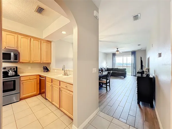 a kitchen with stainless steel appliances a stove a sink and a microwave