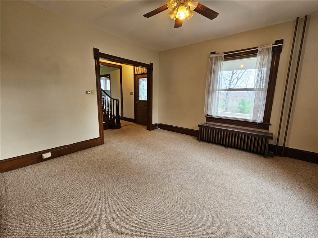 175 Blackfield Road Garrett, PA 15542 - Photo 14 of 37 an empty room with chandelier fan and windows