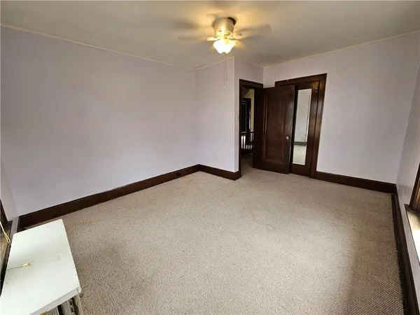 a view of a big room with closet and a chandelier fan